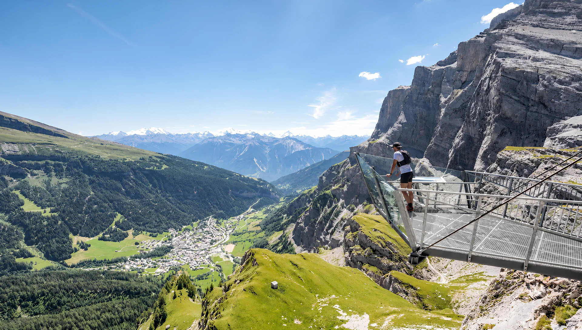 Runners on a sunlit alpine trail beneath the dramatic cliffs of the Swiss Alps